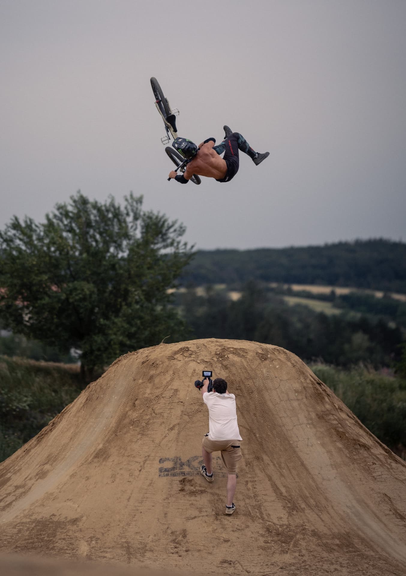 Rider throwing a backflip over a dirt jump